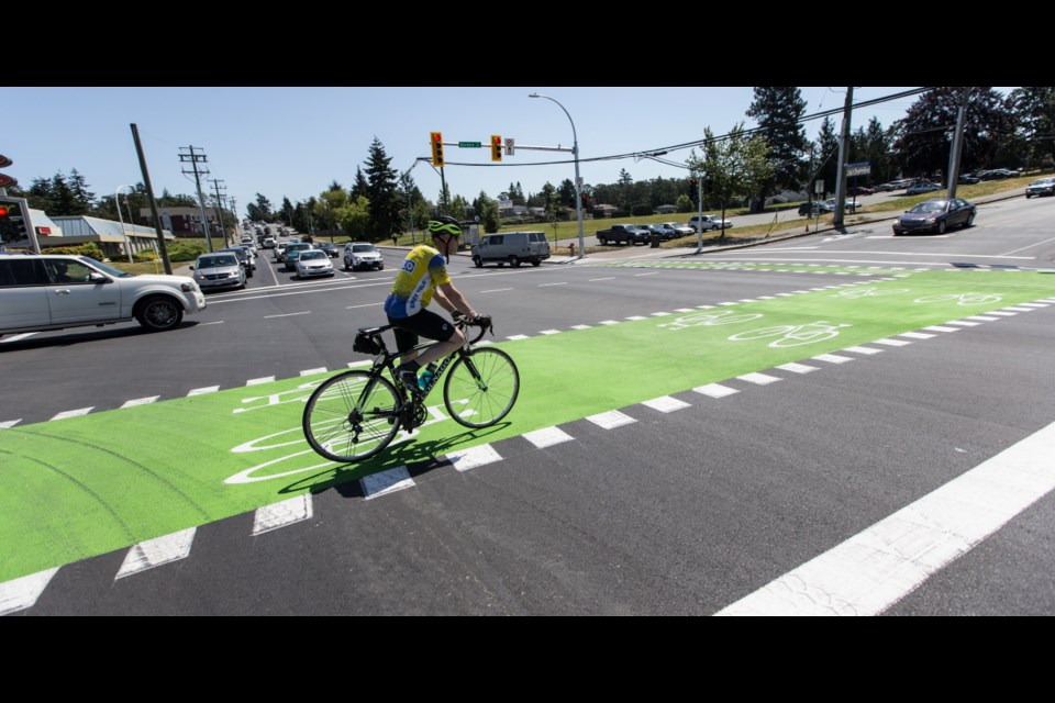 A cyclist rides in a new bike lane at McKenzie Avenue and Borden Street in Saanich on Wednesday, June 28, 2017.
