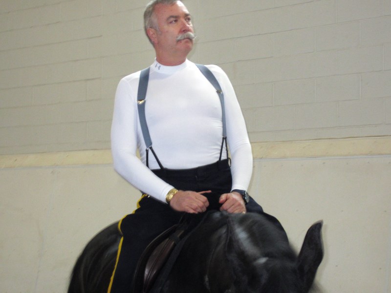Burnaby RCMP Staff Sgt. Maj. John Buis tries his hand at horsemanship with one of the RCMP musical ride horses at the PNE Agrodome in Vancouver in 2013.