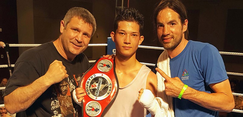 Charley Dawson celebrates his provincial title with coaches Manny Sobral and Dave Robinson