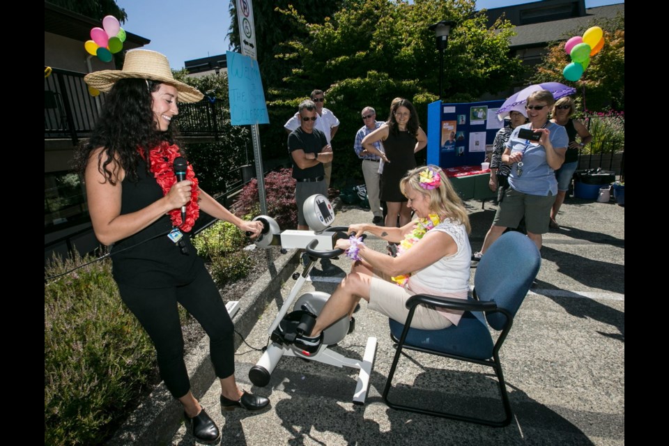 Denise Alexander tries a new Motomed with therapist Michelle Haddad, left, at the Glengarry Hospital Summertime Celebration.