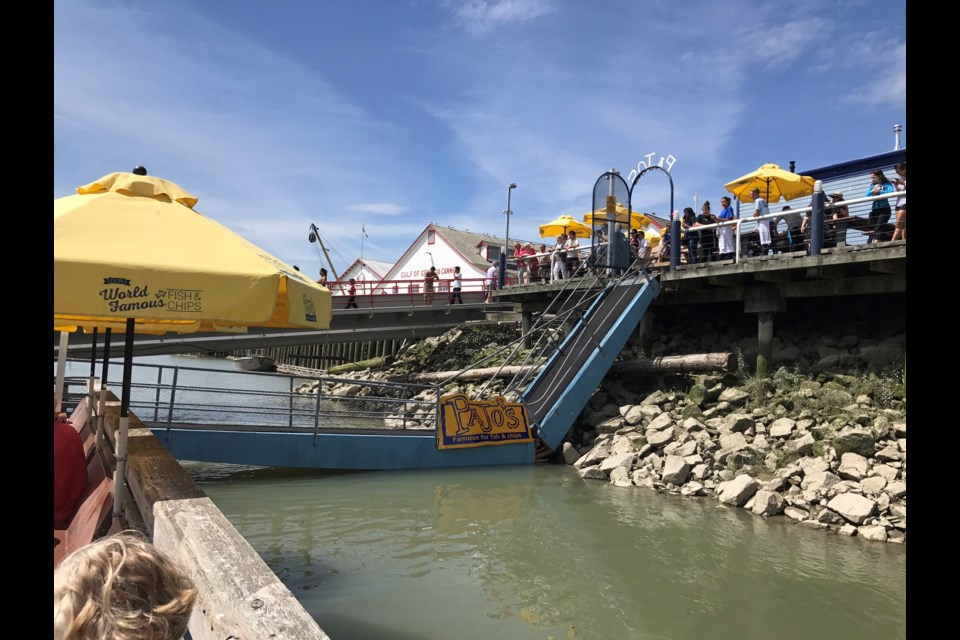 This photo of the collapsed walkway at Pajo's in July 2017 was taken by one of the people stranded on the floating dock. File photo