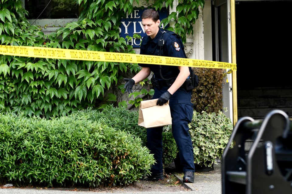 Police searched the area around at West End apartment building Monday. On Sunday, two people were fo