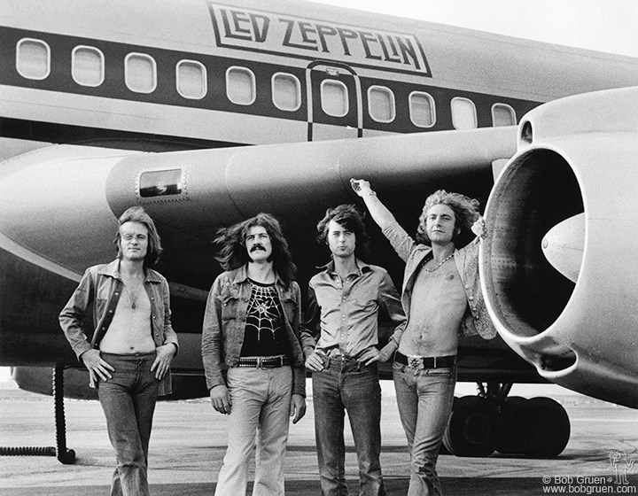 John Paul Jones, John Bonham, Jimmy Page and Robert Plant of Led Zeppelin in front of plane in NY. July 24, 1973. © Bob Gruen / www.bobgruen.com