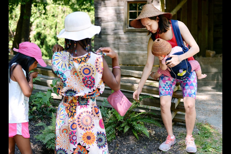 Senaqwila Wyss and 11-month old Kamaya lead a aboriginal medicinal plant tour as a part of First Nations cultural presentations at Burnaby Village Museum.