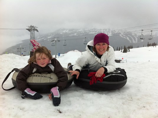 A little girl and her mom get ready for tubing on Whistler Mountain in June.