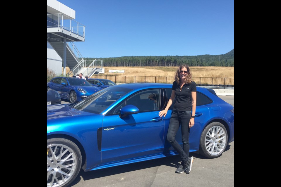 Anja Wassertheurer, director of product and technical communications for Porsche, with a sapphire-blue Panamera Sport Turismo at Vancouver Island Motorsport Circuit.