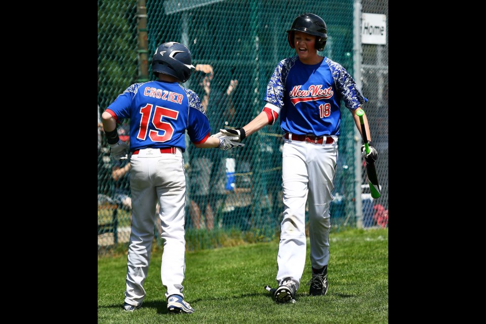 New Westminster’s Cole Crozier, left, celebrates a run with teammate Ben Hewitt during last week’s round-robin action at the district championships at Moody Park. The New West major All-Stars went from underdogs to champions, thanks to some stellar hitting.