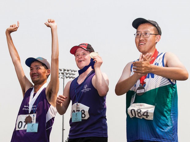 Delta Special Olympics athlete Kurtis Reid (centre) had a weekend to remember at the Special Olympics Summer Games in Kamloops July 6 to 9 as he earned three gold medals in the 100m run/sprint, shot put and the standing long jump.