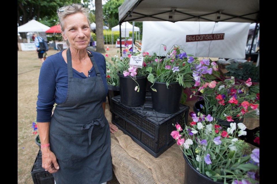 Red Damsel Farm owner Shellie MacDonald at her stand at the Esquimalt Farmers Market.