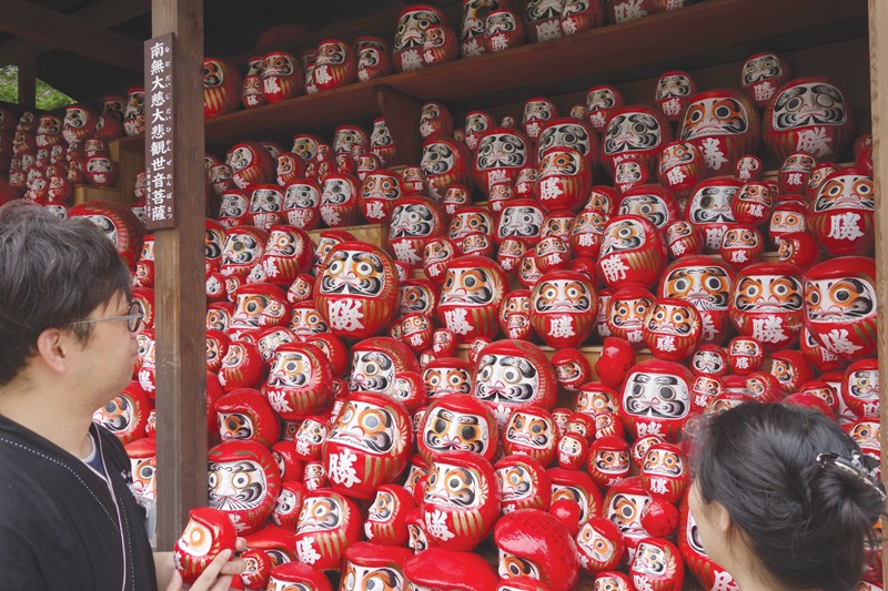 Darumas (tumbling dolls) at the temple of winner’s luck.