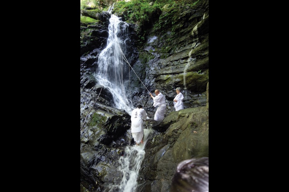 At Shipporyuji Temple, monks lead the climb to waterfall for benediction.