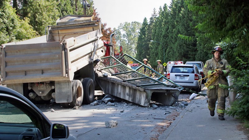 Firefighters on scene at Beaverbrook Drive near Eastlake Road after a dump truck crashed into a pedestrian overpass.