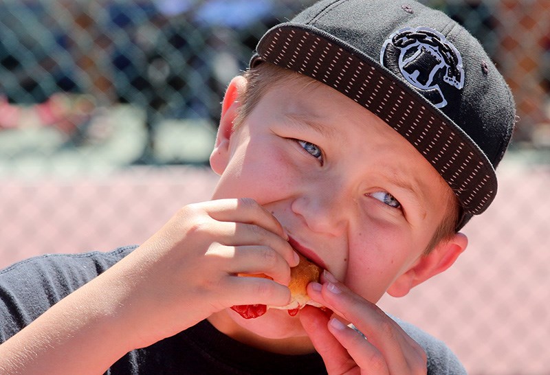 MARIO BARTEL/THE TRI-CITY NEWS
Daniel Schiewe, 10, bites into a messy hotdog at the second annual Mayor's Summertime Celebration held Friday behind Port Moody city hall. The event included a free barbeque, kids' activities and a book carnival.