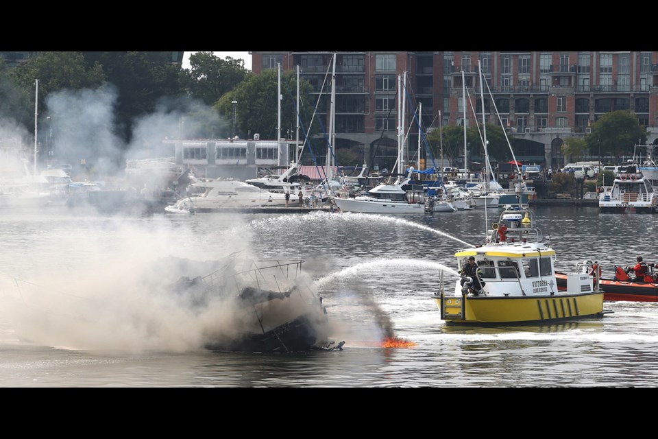 Victoria firefighters battle a boat fire in the Inner Harbour on Wednesday.