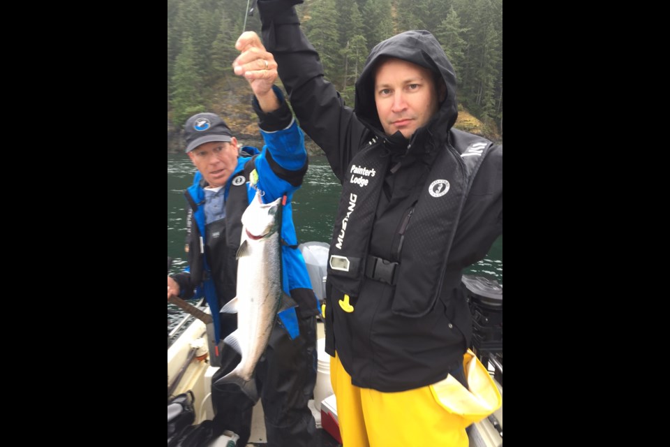 Graeme Wood holds up his catch: a wild Coho salmon, which is a non-retention fish so it had to be thrown back.