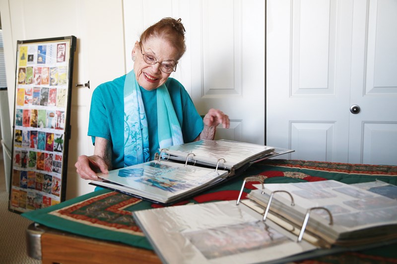 Cecilia Smith goes through a scrapbook of Theatre Under the Stars memorabilia in her Lonsdale apartment. She and her husband Roger have been involved with the musical productions since 1969.