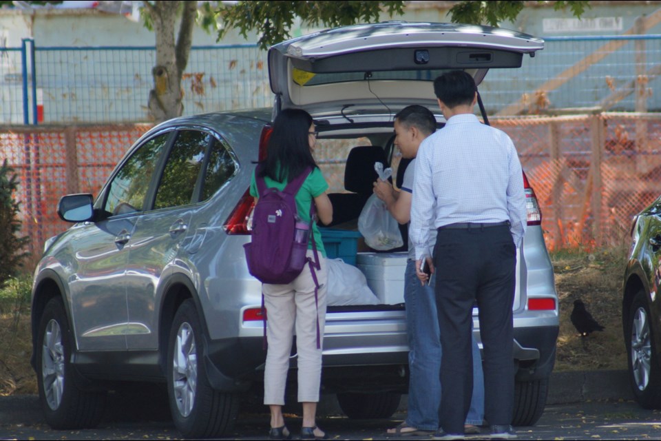 Food-sharing website Weee! and Wechat, a popular Chinese messaging app, have become the major platforms for a black market that has individuals and groups buying and selling all types of food, such as meat, dry goods, desserts, dumplings, fired dishes, soups, hot pots and seafood. Customers buy out of the trunks of cars, such as an undercover Richmond News reporter did last week (above).Sometimes, the items are delivered to homes. Photo by Graeme Wood/Richmond News