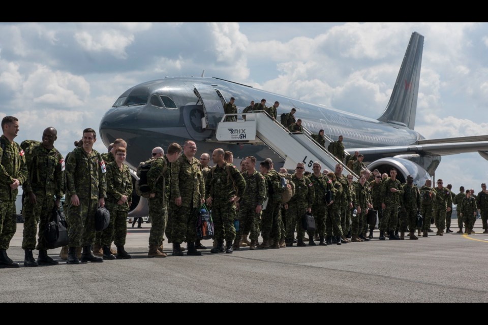 Canadian Armed Forces members from NATO's enhanced Forward Presence Battlegroup in Latvia arrive at Riga International Airport as part of Operation Reassurance on June 10.