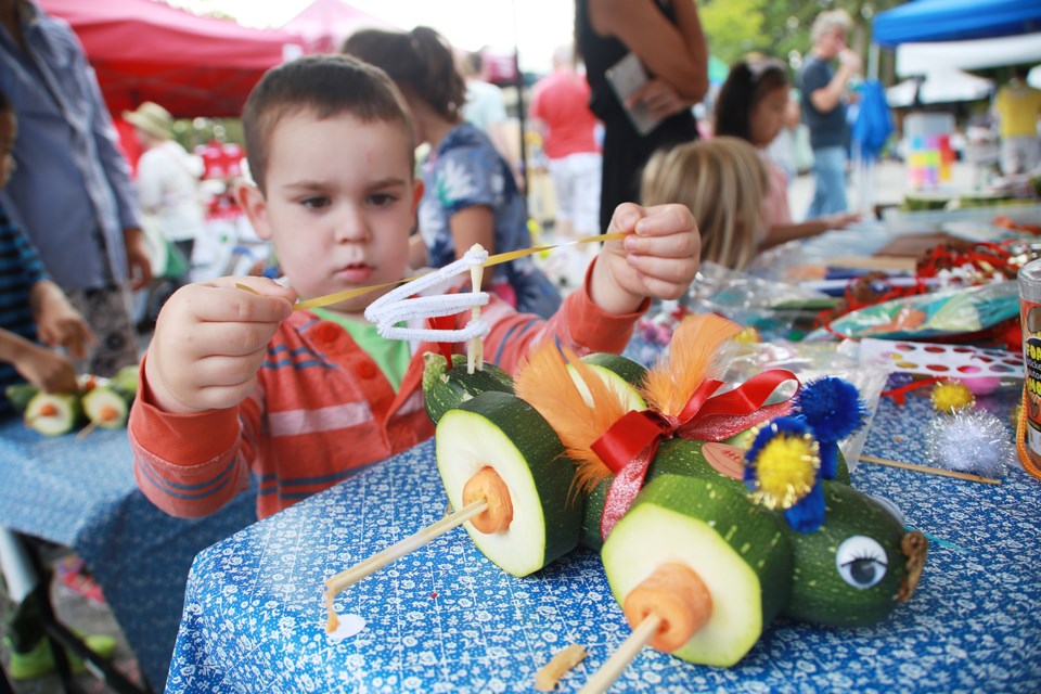 Three-year-old Calum Zwiers puts some final touches on his amazing vegetable vehicle.