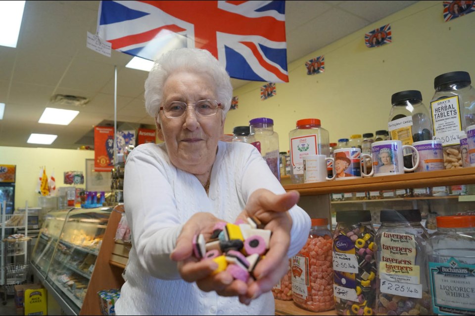 Mary Carter, longtime proprietor of Mary’s British Sweets in Steveston, shows off some licorice allsorts, just some of the mouth-watering candy for sale in her shop. After 35 years, the 82-year-old is closing her Steveston store to move it closer to where she lives in Langley. Photo by Graeme Wood /Richmond News
