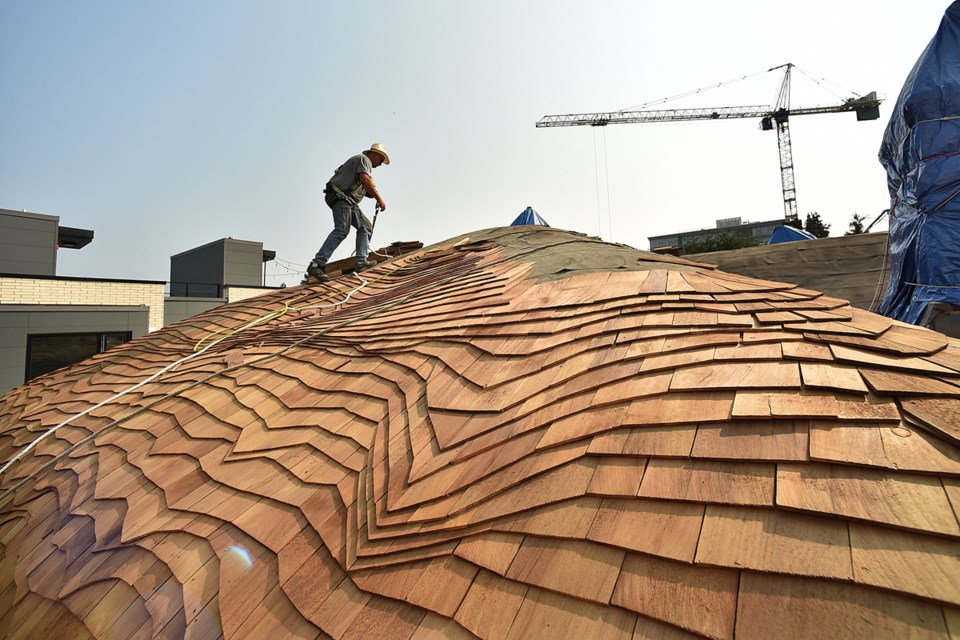 The laborious task of re-roofing the so-called "Hobbit house" on West King Edward Ave. is underway. Photo Dan Toulgoet