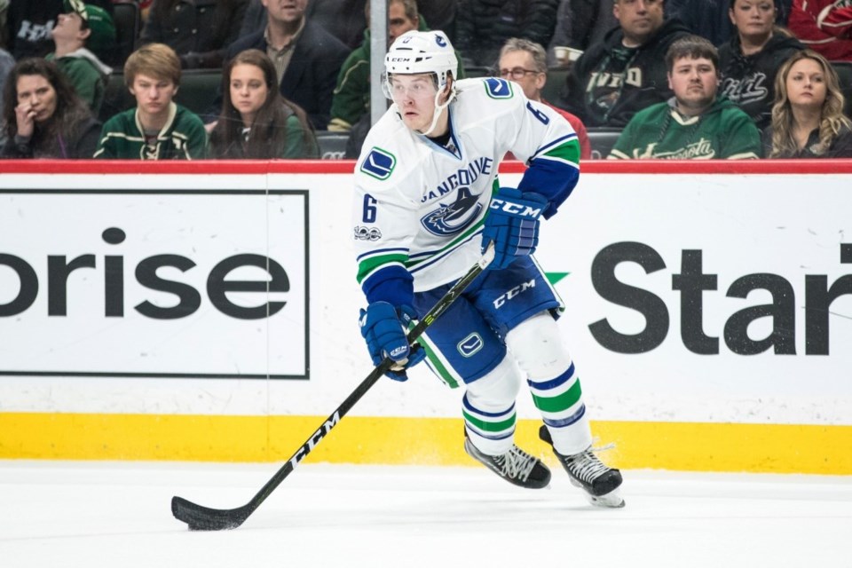 Brock Boeser skates with the puck in rookie debut