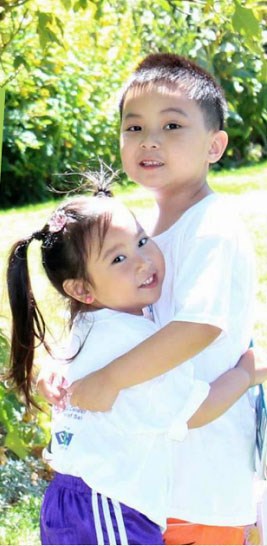 Lazarus Banez, 5 (right) hugs his three-year-old sister Estella. Lazarus inspired a book, which is being launched at the Richmond Olympic Oval this weekend. Photo submitted