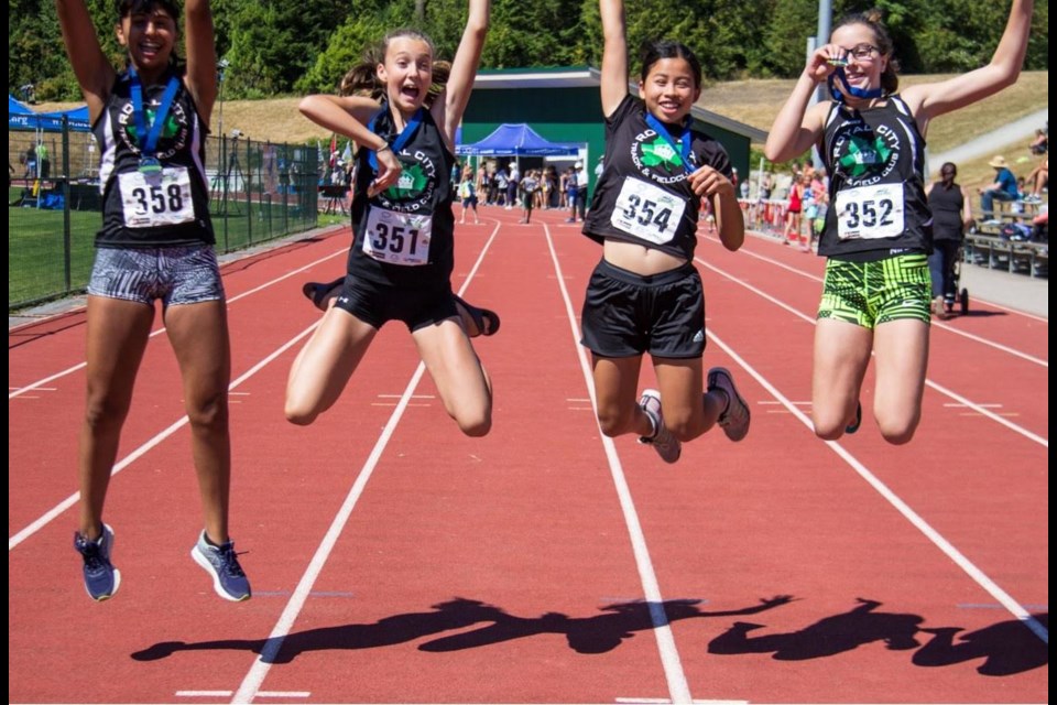 The Royal City Track and Field Club's medley relay, in girls 13 division, celebrate their silver medal.