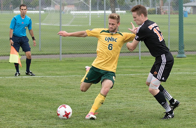 Brett Bobier of the UNBC Timberwolves lets go a shot in close proximity to Adam Swanson of the Thompson Rivers University WolfPack during Saturday's season-opener at North Cariboo Field. The teams played oi a 1-1 tie. In Sunday's reamatch, UNBC walked off with a 2-1 victory.