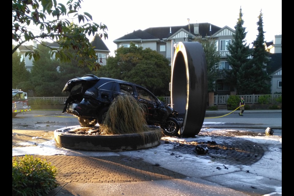 A car jumped the curb at Terra Nova's shopping plaza and crashed into a public art display, momentarily creating a ring of fire Sunday morning (Aug.27, 2017).