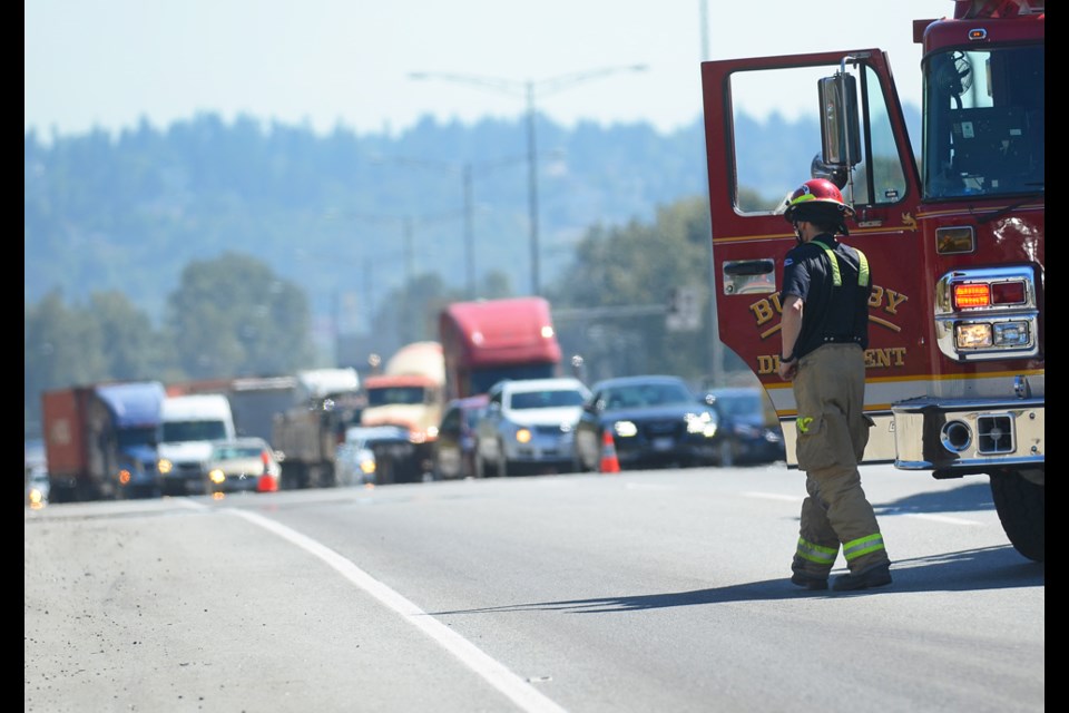 Traffic piles up on Highway 1 east of North Road as emergency crews work to contain a diesel spill from a dump truck in the westbound lanes Monday.