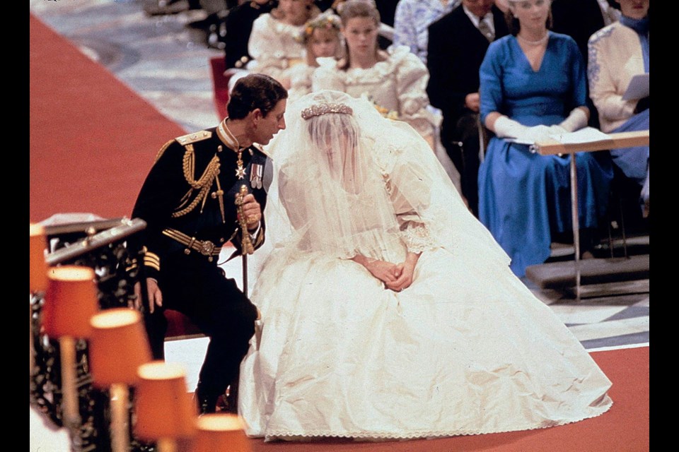 Prince Charles speaks with Diana during their wedding ceremony in St. Paul's Cathedral in London on July 29, 1981. Her silk taffeta gown by David and Elizabeth Emanuel featured a 7.6-metre train.