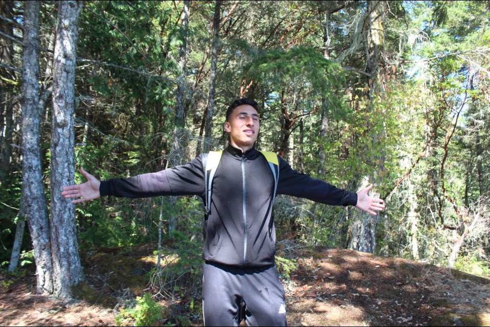 Ayman Al-Sultan, 19, breathes in the wooded surroundings in East Sooke Park. He sees himself playing soccer for the Vancouver Whitecaps.