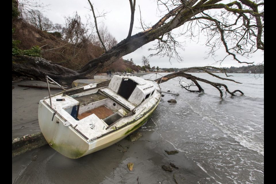 A derelict boat is seen on the beach in Cadboro Bay in February. At the Union of B.C. Municipalities annual convention this month, Oak Bay, Victoria and Ladysmith will call for a national strategy for dealing with abandoned vessels.