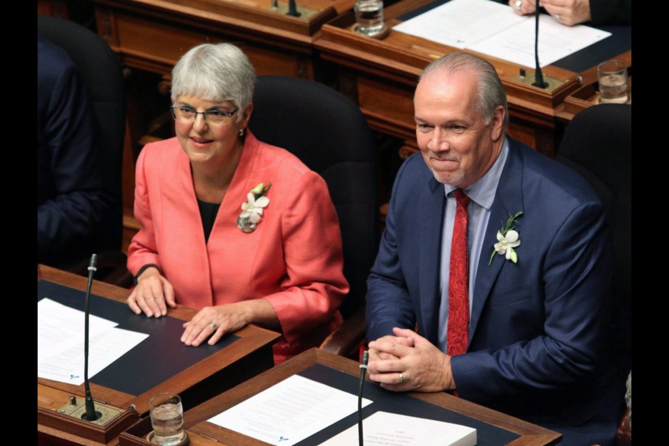 Finance Minister Carole James and Premier John Horgan await the speech from the throne in the legislature on Friday, Feb. 14, 2020. The budget James delivered Monday fulfils promises from the election campaign and the throne speech, but rising interest rates could upset the government’s plans.
