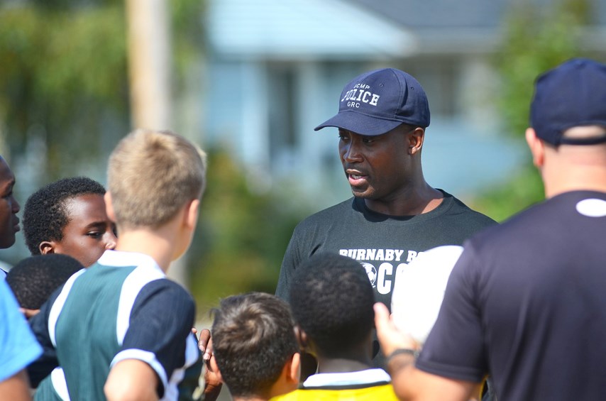 Burnaby RCMP Const. Kwame Amoateng gives instructions to a group of young soccer players at the Burnaby RCMP’s first-ever youth soccer camp at Edmonds Park last month.