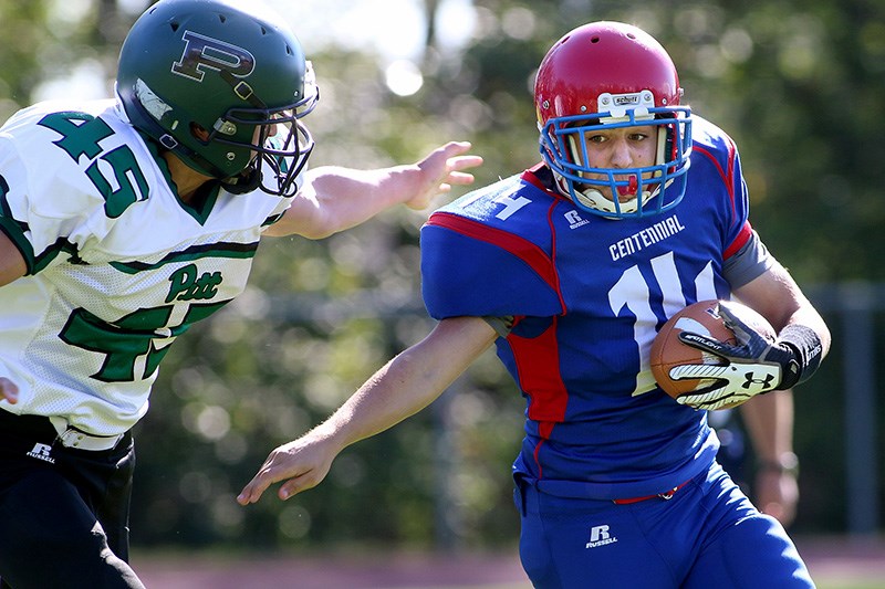 MARIO BARTEL/THE TRI-CITY NEWS
Centennial tailback Alex Celenza tries to escape a Pitt Meadows tackler in the first quarter of their BC Secondary School Football Association junior varsity game, Wednesday at Centennial secondary school. Pitt Meadows won the game 16-12.