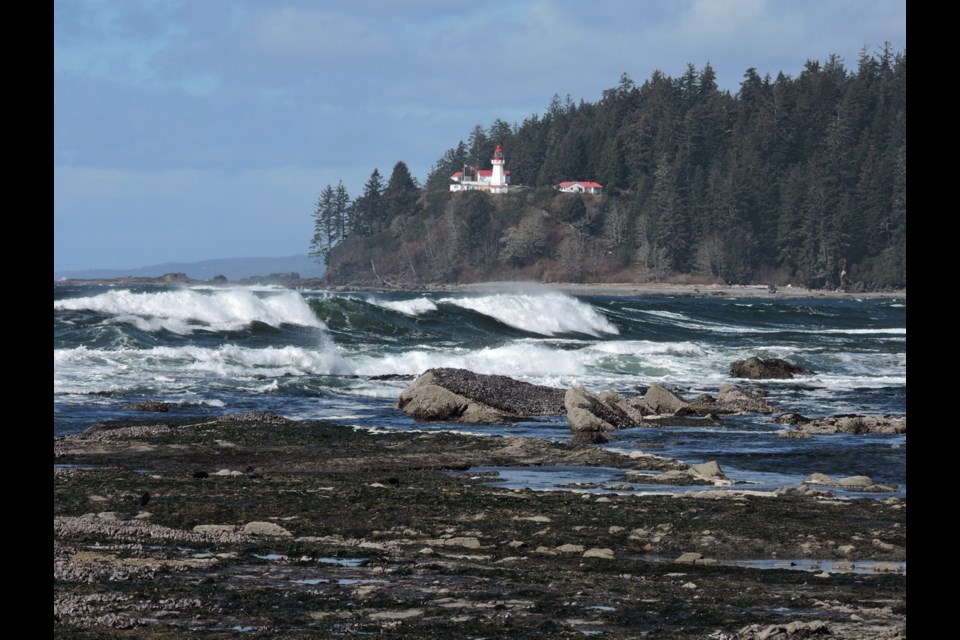 Waves break on the beach below the Carmanah Point lighthouse. Lightkeeper Justine Etzkorn impressed a Victoria family by hauling the corpse of a massive sea lion out of a creek from which West Coast Trail hikers draw drinking water.