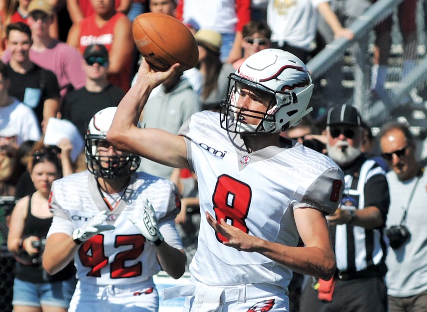 Carson Graham quarterback Charlie McMillan fires a pass during Buchanan Bowl 31 played Saturday at Carson. The Eagles trailed early but scored 41 points in the second half on their way to a 61-21 win over Handsworth. photo Paul McGrath, North Shore News