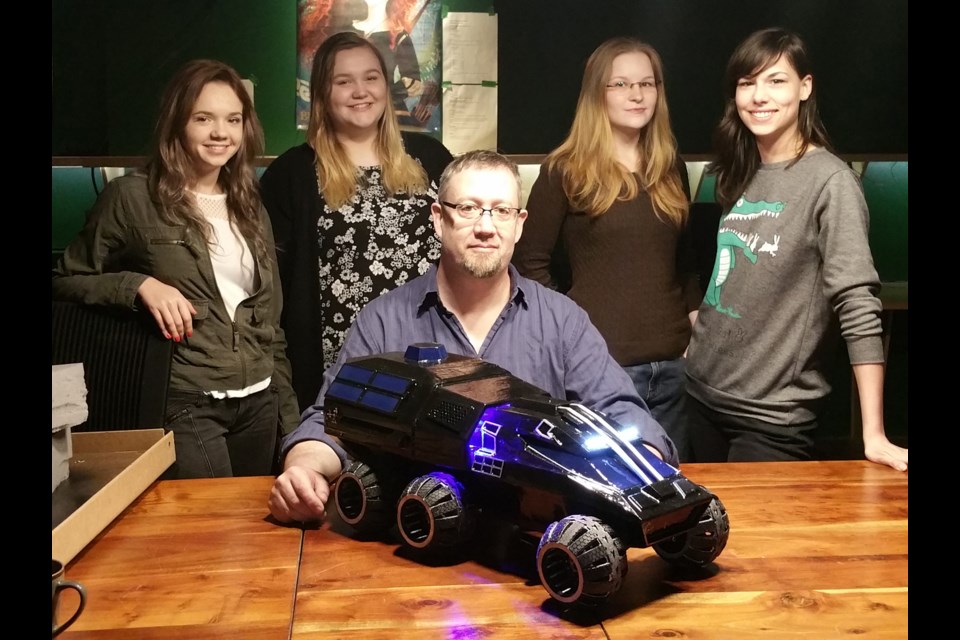 CG Masters School co-founder Nicholas Boughen shows off the Mars Rover replica he and his students built for the Kennedy Space Center. He was helped by students, from left, Lena Engel, Brooke Sanders, Anna Glushkova and Kiera Chycoski. Also part of the team was Stephen Tran (absent from photo).