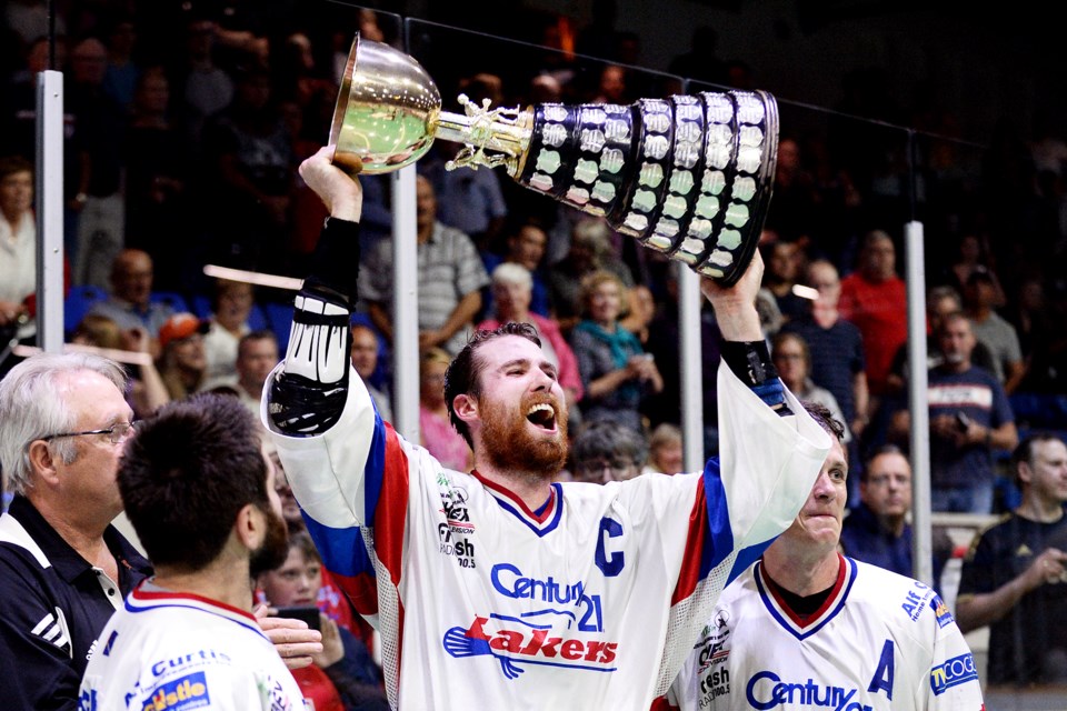 Peterborough captain Robert Hope lifts the Mann Cup to celebrate his team's 4-2 series win over New Westminster.