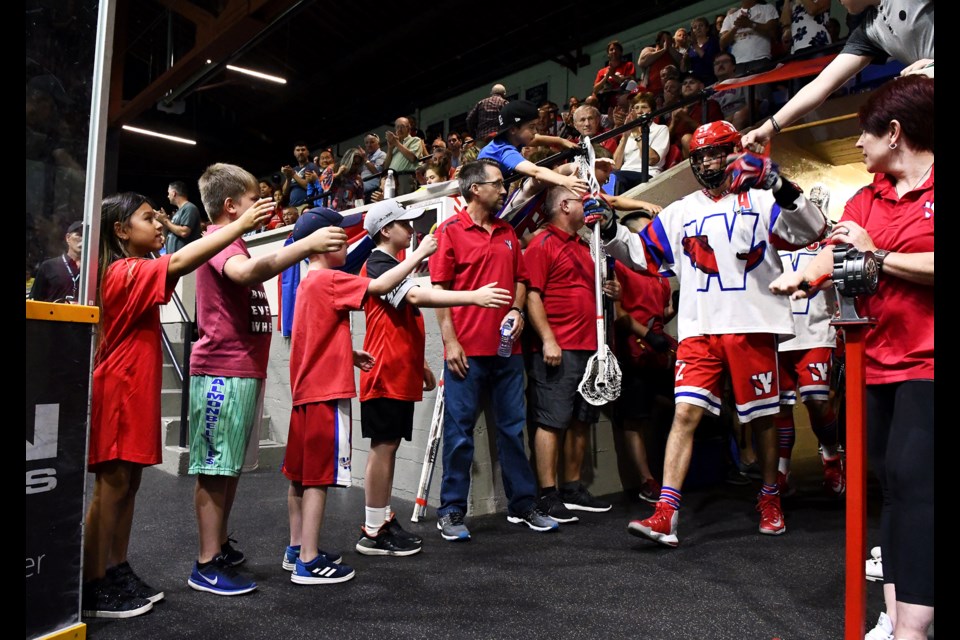 The New Westminster Salmonbellies, led by Brett Mydske, head onto the floor cheered on by young fans prior to the start of Game 1 of the Mann Cup championship series against Peterborough.