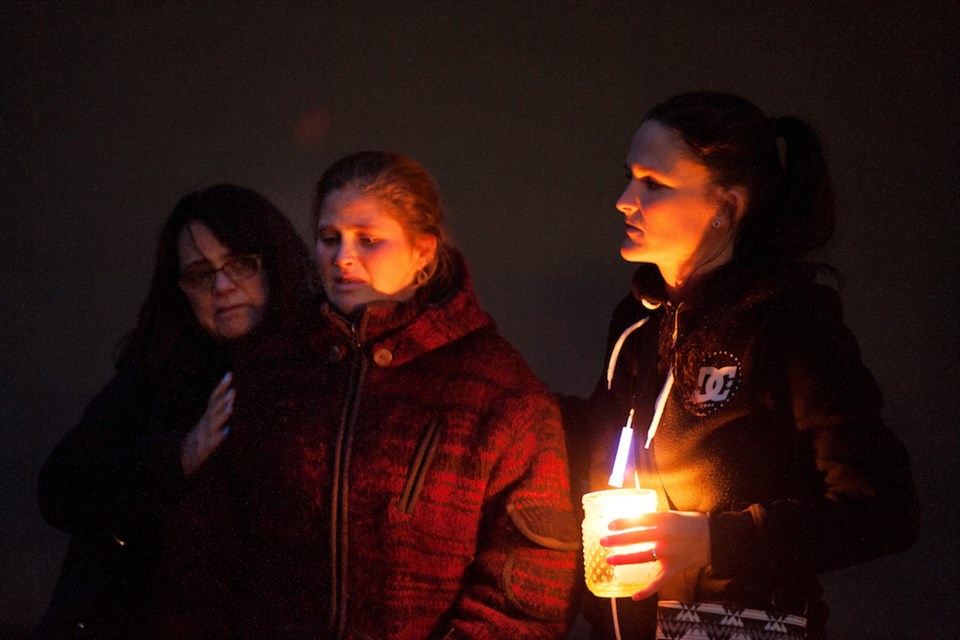 Valley Calderoni, founder of Canine Valley rehabilitation centre, being comforted at the Wednesday night vigil.