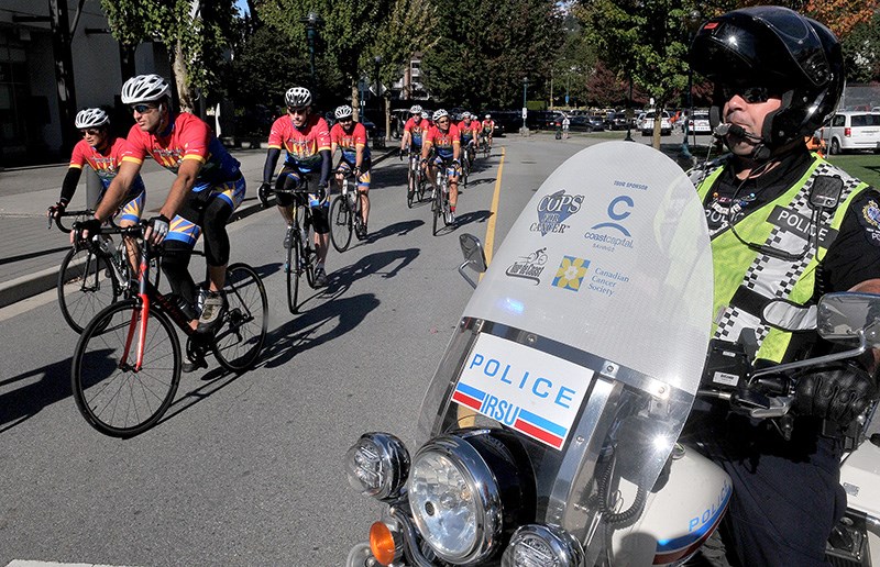 MARIO BARTEL/THE TRI-CITY NEWS
Riders in the annual Cops for Cancer Tour de Coast arrive at Glen Pine Pavillion in Coquitlam on Tuesday morning with a police escort, of course. The tour, which runs from Sept. 20 to Sept. 28, is comprised of members of law enforcement and emergency services personel from around Metro Vancouver. They cycle hundreds of kilometres Sechelt to Richmond to raise money for cancer research. Two members of the Coquitlam RCMP, Cst. Sienna
Cooke and Cpl. Neil Roemer, are participating in this year's ride, while Cst. Doug Riley of the Port Moody police is riding in the Tour de Valley.
“Everyone is affected by cancer in some way, and I especially feel
for kids with cancer,” Cooke said. "I want to do something to help make
sure kids with cancer can still be kids.”
This year's tour has already raised more than $500,000.
After a brief pitstop in Coquitlam, the peloton rode on to Maple Ridge.