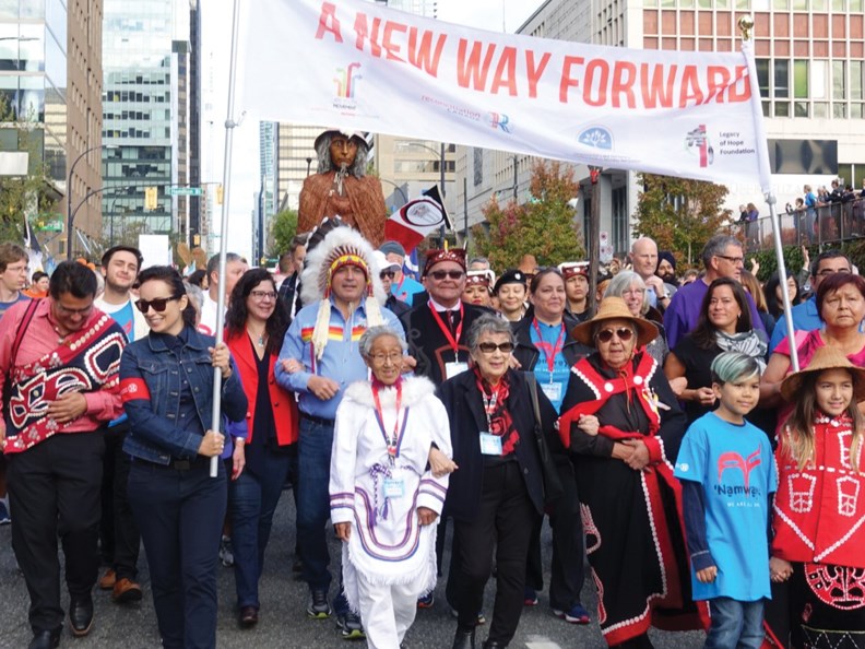 Annie Aculiak of Davis Bay (in white) marches in the front row at last Sunday’s Walk for Reconciliation in Vancouver.