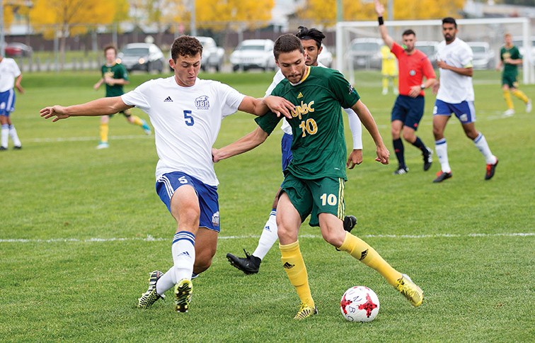 UNBC Timberwolves midfielder Cheona Edzerza looks to make a play past UBC Thunderbirds defender Connor Guilherme on Saturday at NCSSL field. The two teams met in the second game of a weekend doubleheader. Citizen Photo by James Doyle