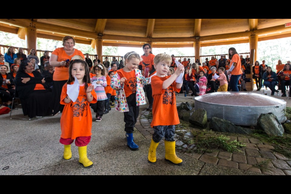Children sing and dance in orange shirts on Friday at Na'tsa'maht, the First Nations gathering place at Camosun College's Lansdowne campus, in remembrance of the Indigenous children who were forced to go to residential schools.