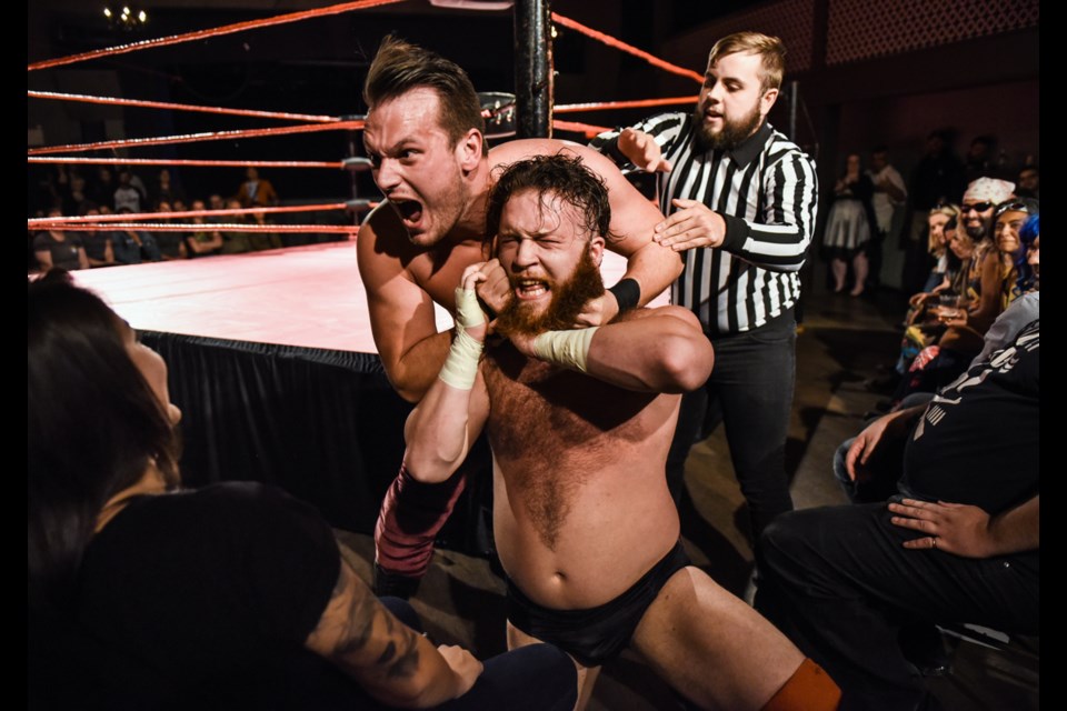 Professional wrestler Todd Quality put the choke on Nick Price during Saturday night’s Glam Slam VII at the WISE Hall. Glam Slam is a mash-up between classic professional wrestling and burlesque featuring some of the city’s finest wrestlers and performers. Photo by: Rebecca Blissett