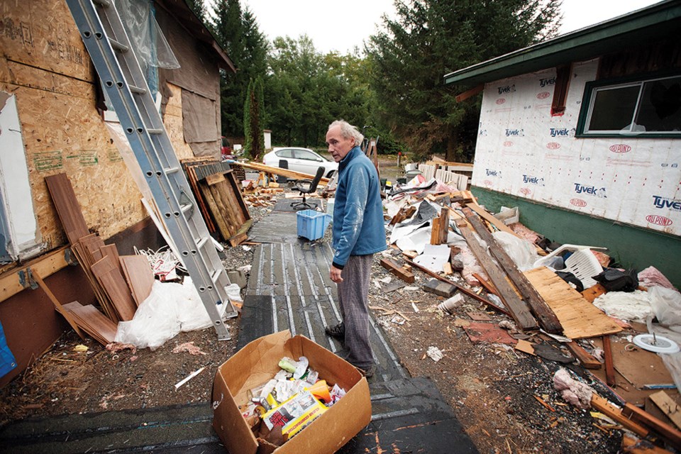 Tom Green, one of the last tenants of the Riverside Trailer Park, takes stock of a neighbouring mobile home on Friday, the day before the eviction deadline Saturday. Many of the units were wrecked by their owners who could not afford to relocate the trailers, Green says