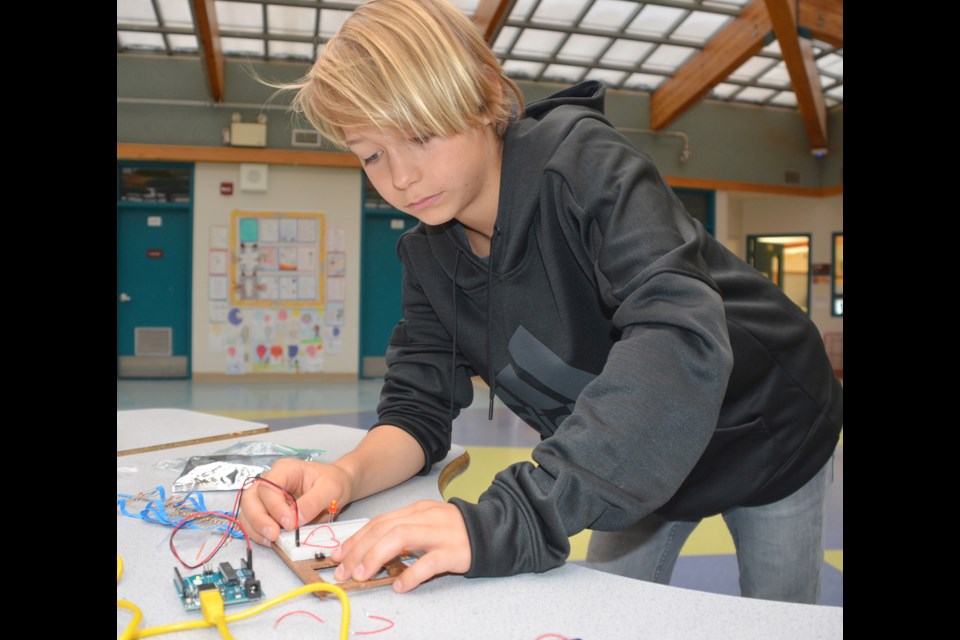 Daveed Vodonenko works on a circuit board to make a light as part of Taylor Park Elementary’s robotics, electronics and technology initiatives to help get students involved in learning.